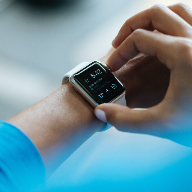 A person holding an Apple Watch, showcasing its sleek design and advanced features for convenient and stylish wearable technology.